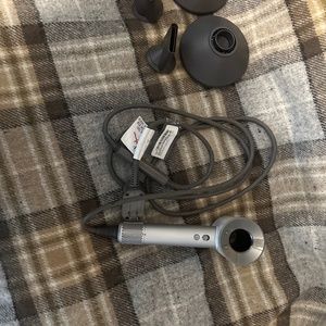 Dyson white hair dryer with attachments and storage case. Barely used.